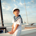 Portrait of young sailor near yacht, outdoor