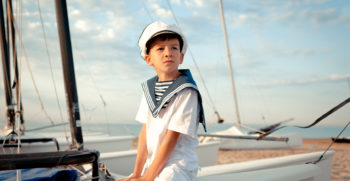 Portrait of young sailor near yacht, outdoor